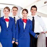 Friendly cabin crew in an airplane smiling